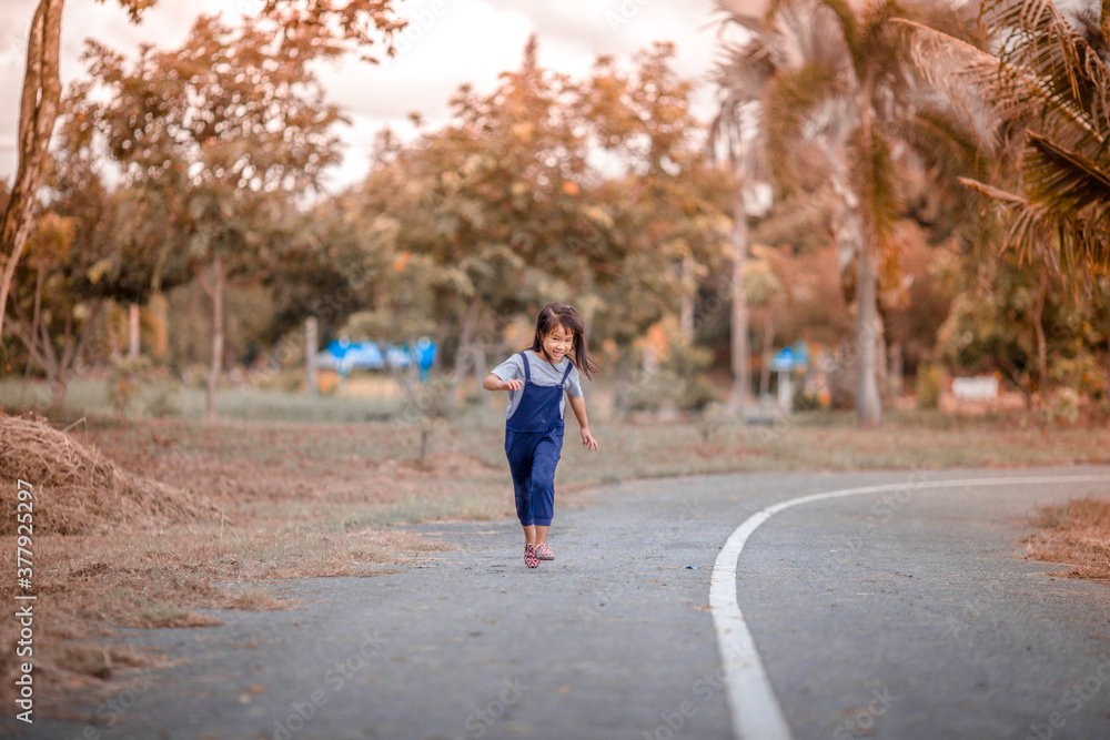 Blurred abstract background of Asian girls, cute in a bright dress, playing on the street or in a park, when parents watch closely. Blurred abstract background of Asian girls, cute in a bright dress, playing on the street or in a park, when parents watch closely.