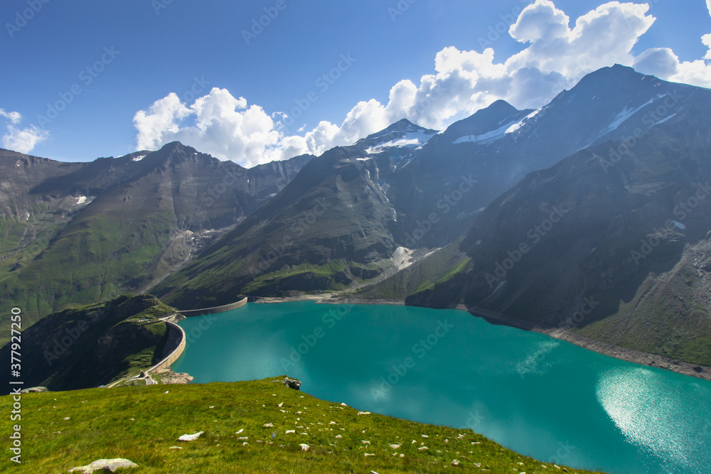 Beautiful view of high mountain lake near Kaprun.Hike to the Mooserboden dam in Austrian Alps.Quiet relaxation in nature.Wonderful nature landscape,turquoise tranquil lake,holiday travel scene