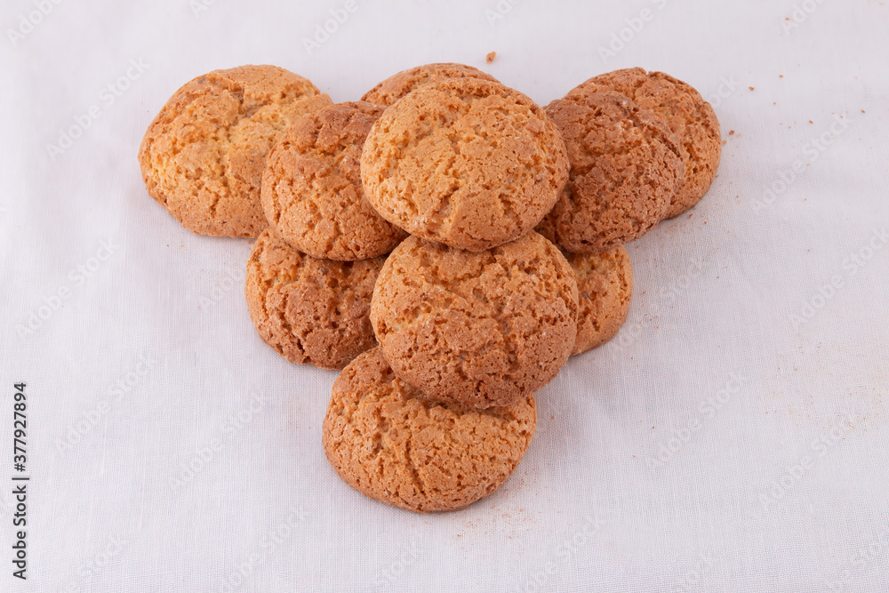 Pyramid pile of delicious almond cookie biscuits on white Pyramid pile of delicious almond cookie biscuits on white