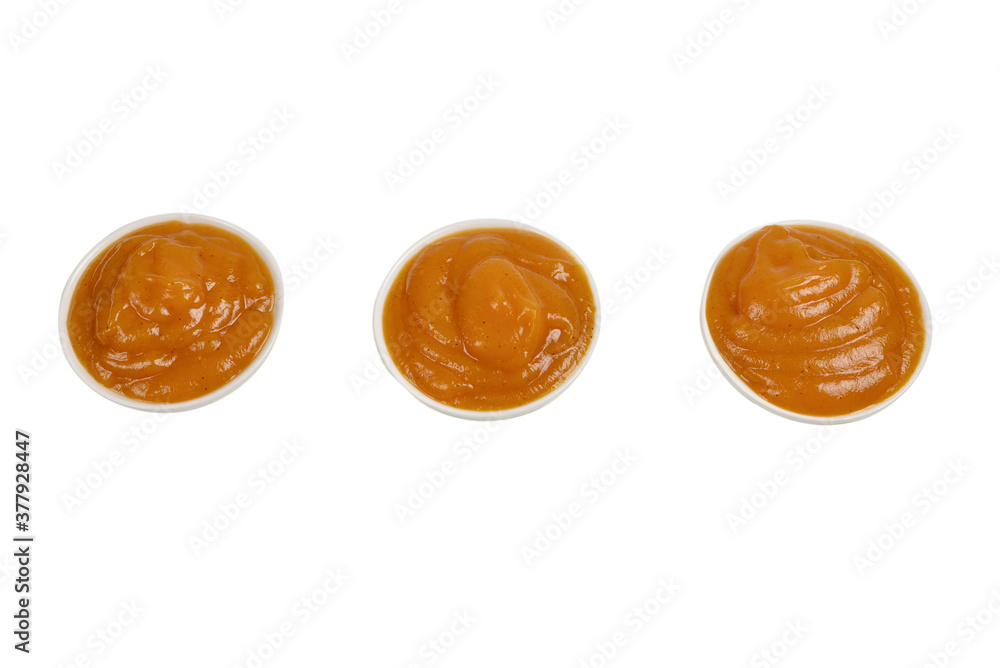Orange sauce in white plate on white background. Orange sauce in white plate on white background.