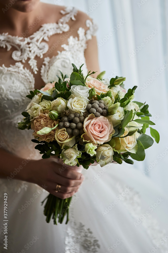 bouquet in hands of the bride, woman getting ready before wedding ceremony