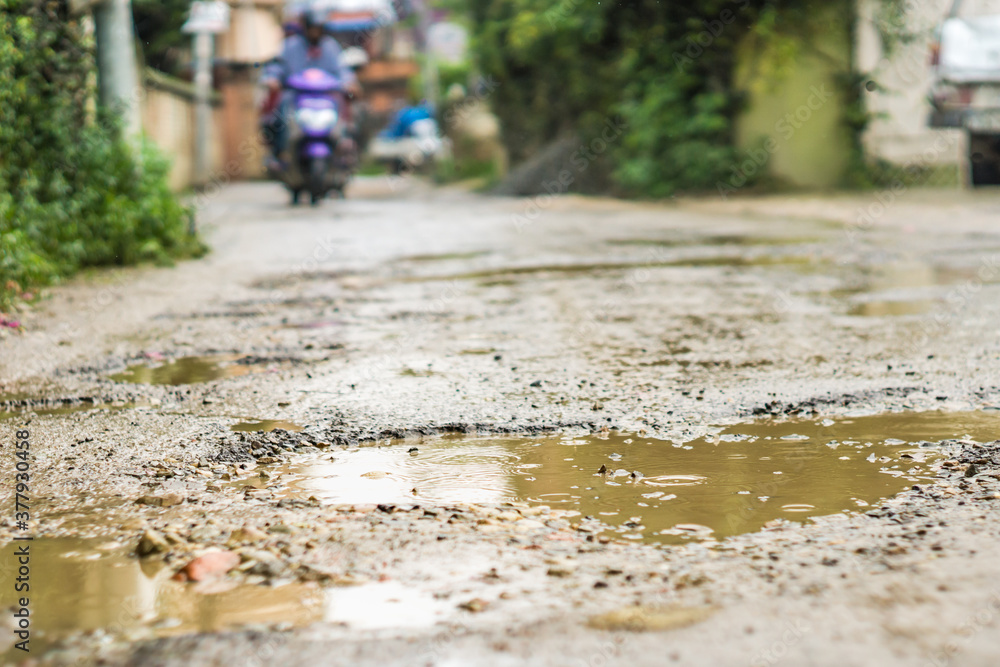Mud puddle in road pothole on rainy day Mud puddle in road pothole on rainy day