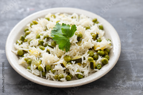 boiled rice with green vegetables in the dish