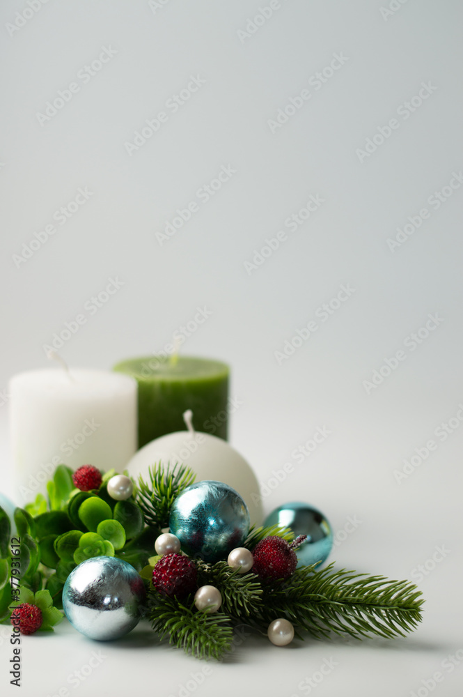 Christmas composition with candles in green-blue tones.