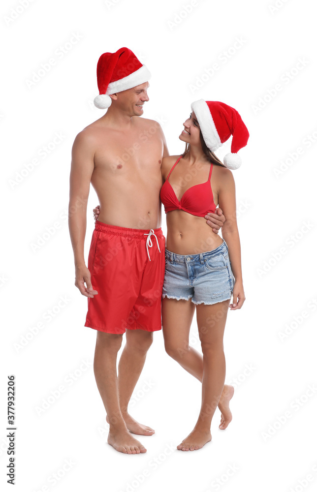 Happy couple with Santa hats together on white background. Christmas vacation Happy couple with Santa hats together on white background. Christmas vacation