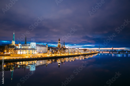 Riga, Latvia, Europe. Cityscape In Morning Time. Night View Of Castle, Dome Cathedral And St. Peter's Church. Popular Place With Famous Landmarks. UNESCO. Old Town In Street Christmas Decoration
