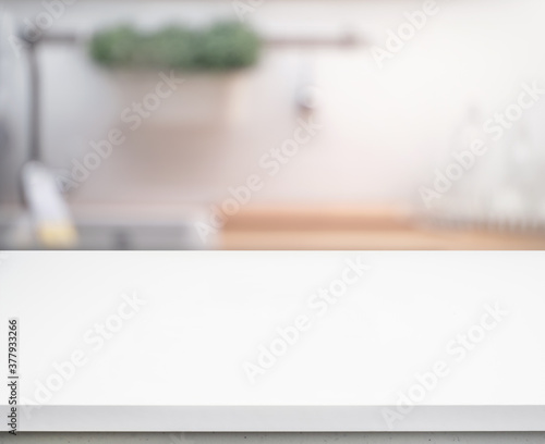 Selective focus/White table top on blur kitchen counter (room)background © hakinmhan