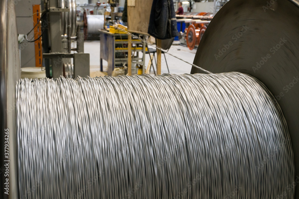 Fototapeta premium A coil of power electric cable in yellow insulation on a metal coil