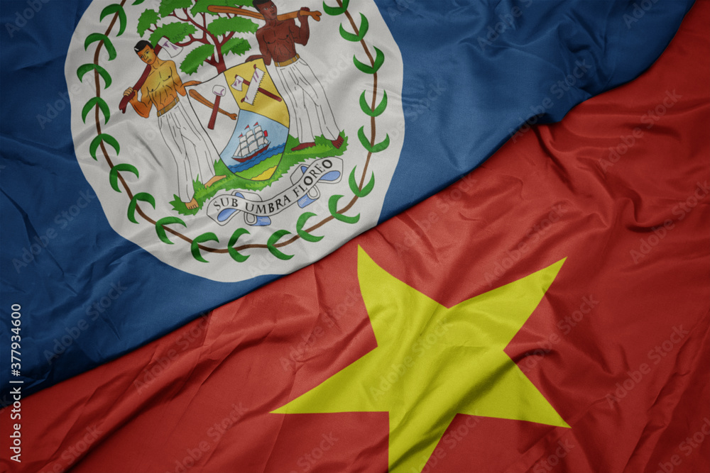 waving colorful flag of vietnam and national flag of belize.