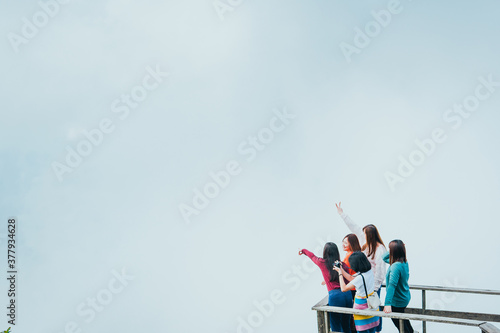 group asian woman traveler open arms and embracing nature from top of mountain in spring season