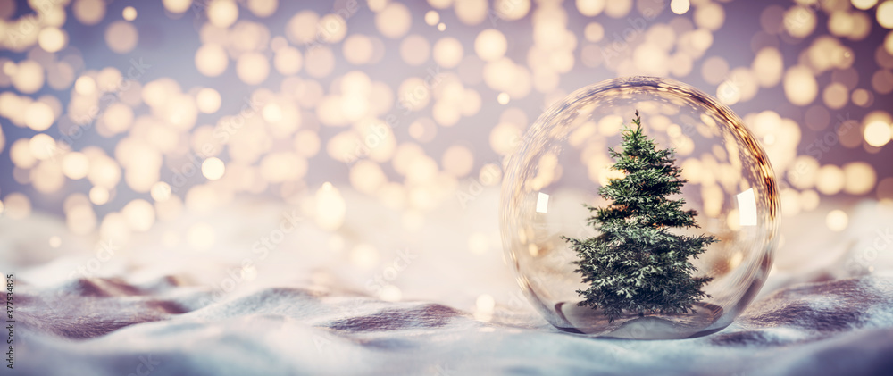 Christmas tree in glass ball on snow. Glitter lights - obrazy, fototapety, plakaty 