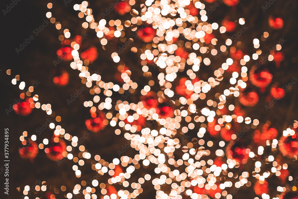 Christmas tree with defocused lights and red balls. defocused new year background Christmas tree with defocused lights and red balls. defocused new year background