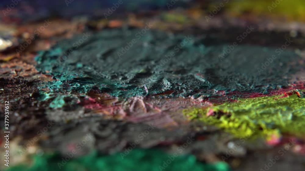 Dried up multicolored paints on a wooden palette Dried up multicolored paints on a wooden palette