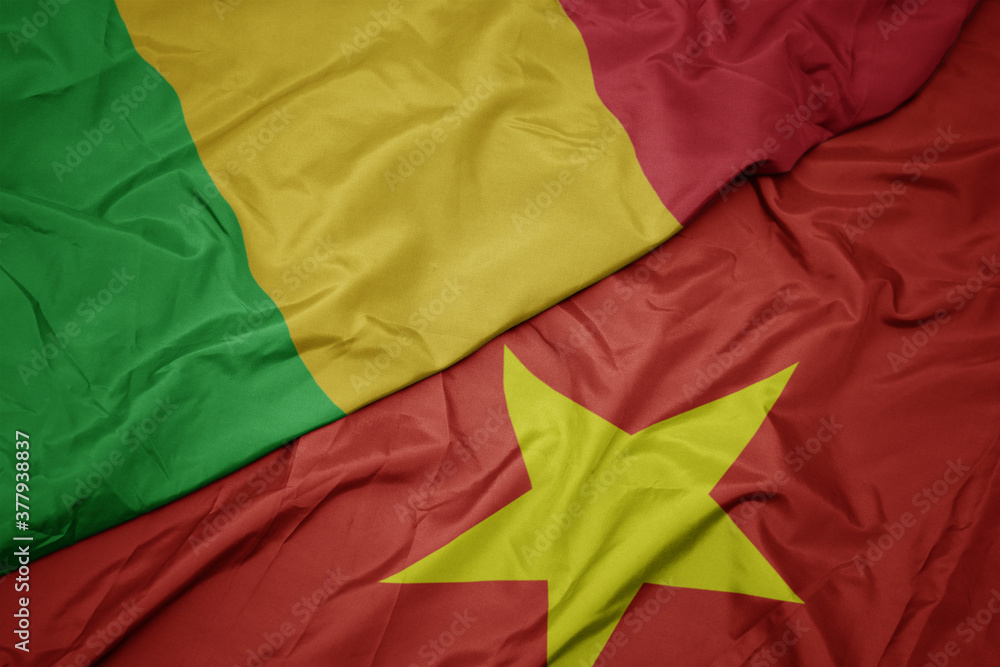 waving colorful flag of vietnam and national flag of mali. waving colorful flag of vietnam and national flag of mali.