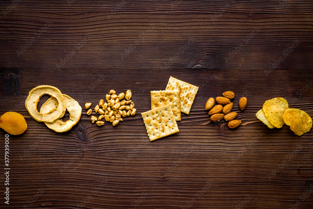 Fototapeta premium Flat lay of appetizers and snacks overhead. Nuts and dried fruits with crackers