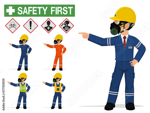 An industrial worker with respirator is pointing to something.