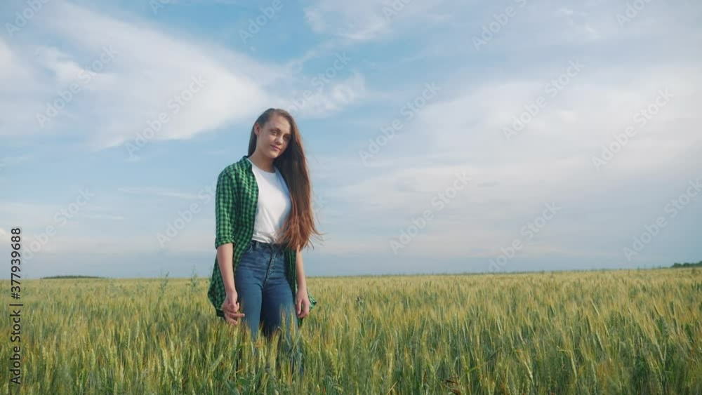 teen girl rejoices standing in the field to meet the sunlight hair flutter. happy family freedom freedom dreams people outdoors childhood concept. girl farmer portrait wheat field in jeans and a shirt teen girl rejoices standing in the field to meet the sunlight hair flutter. happy family freedom freedom dreams people outdoors childhood concept. girl farmer portrait wheat field in jeans and a shirt