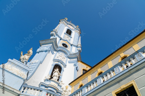 Clocktower of the Augustinian Canons Durnstein abbey which was founded on a rock cliff high above the Danube in 1410. With its blue paint it is one of the most famous landmarks of Austria photo