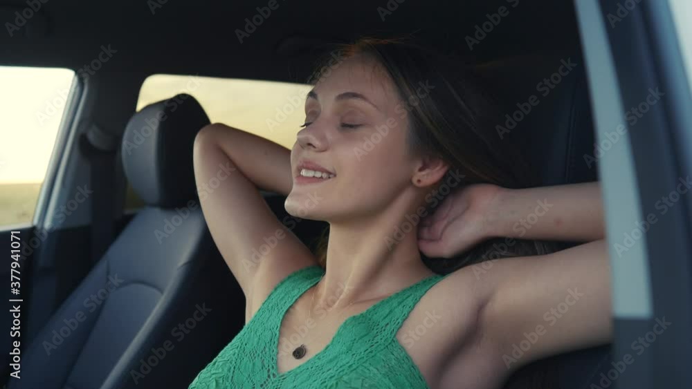 young free happy positive girl relax dream closed her eyes looking up in a car. teenager daughter dreaming relaxes throws her hands behind her head resting lifestyle after stress. woman happy family young free happy positive girl relax dream closed her eyes looking up in a car. teenager daughter dreaming relaxes throws her hands behind her head resting lifestyle after stress. woman happy family