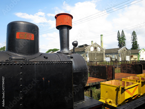 Huwei Sugar Factory (虎尾糖廠) light railway train with the chimney of the sugar factory in Huwei Township, Yunlin County, TAIWAN