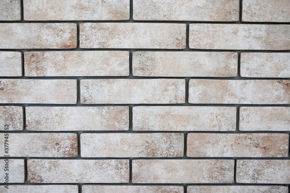 Beige and gray brick wall background Beige and gray brick wall background