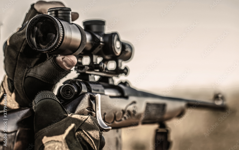 Fototapeta premium Shooter sighting in the target. Hunt hunting rifle. Hunter man. Hunting period. Male with a gun. Close up. Hunter is aiming