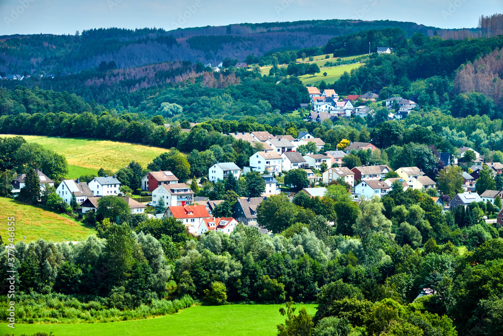 Aerial view of a village in the Sauerland near Dortmund, Germany, with meadows, forests and individual houses