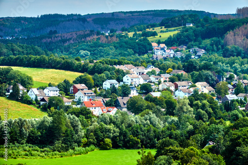 Aerial view of a village in the Sauerland near Dortmund  Germany  with meadows  forests and individual houses