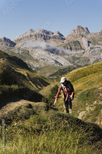 Woman hiker climbing scenic mountain landscapes in the Pyrenees