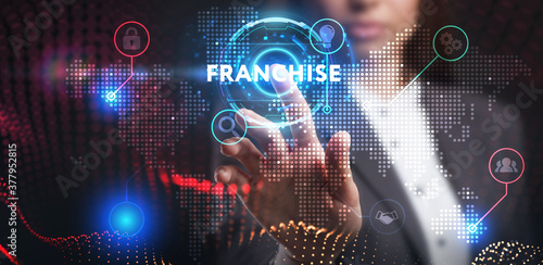Business, Technology, Internet and network concept. Young businessman working on a virtual screen of the future and sees the inscription: Franchise