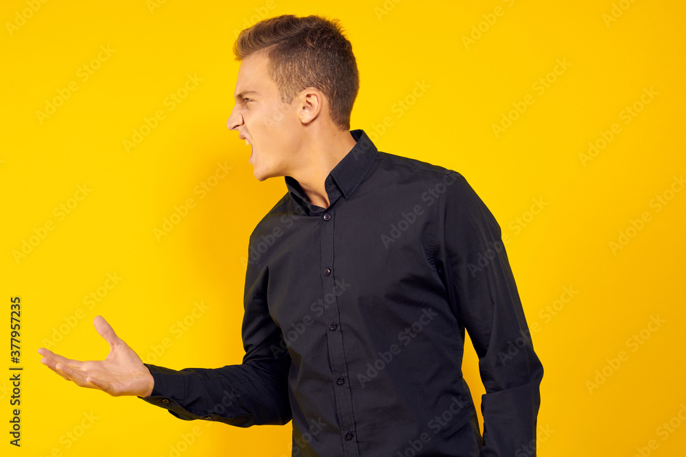 emotional man in black shirt lifestyle yellow isolated background emotional man in black shirt lifestyle yellow isolated background