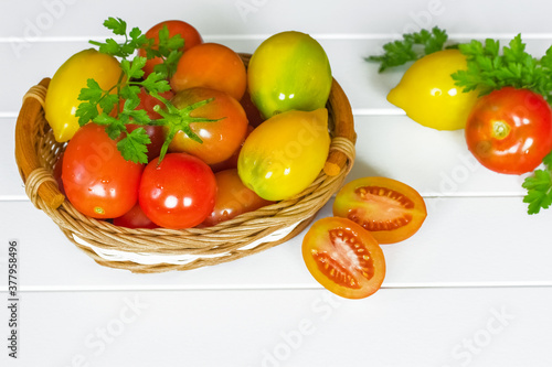 Slika na platnu fresh ripe red tomatoes in a wicker basket on a white background