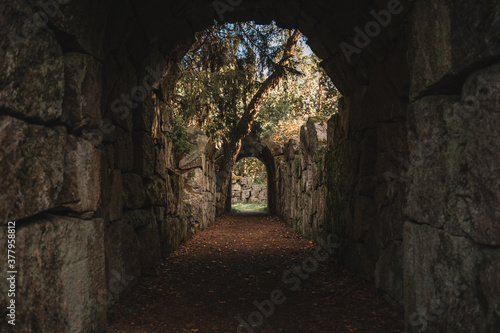 Old stone ruins with archway paths in a Finnish park