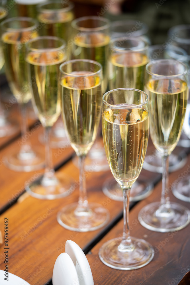 Glasses with golden champagne, bubbles and beautiful bokeh. alcoholic start to the feast. vertically. Glasses with golden champagne, bubbles and beautiful bokeh. alcoholic start to the feast. vertically.