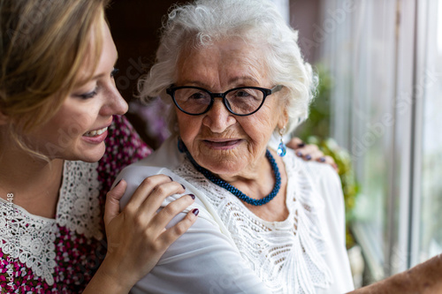 Young woman spending time with her elderly grandmother at home
 photo