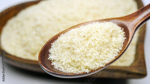 Close up of psyllium (ispaghula) husk in wooden spoon.Psyllium husk also called isabgol is fiber derived from the seeds of Plantago ovata plant found in India. Selective focus. photo