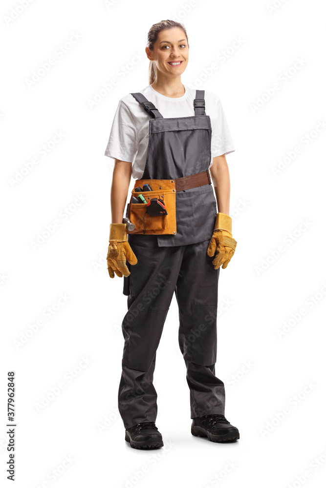 Full length portrait of a repairwoman with a tool belt in a gray uniform Full length portrait of a repairwoman with a tool belt in a gray uniform