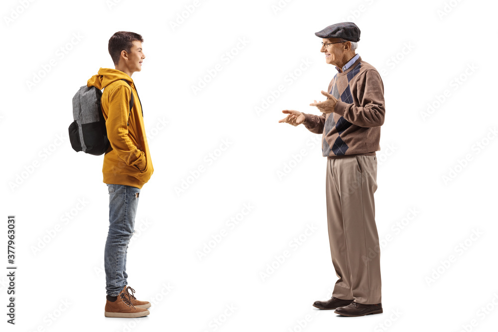Full length profile shot of an elderly man talking to his teenage grandson Full length profile shot of an elderly man talking to his teenage grandson