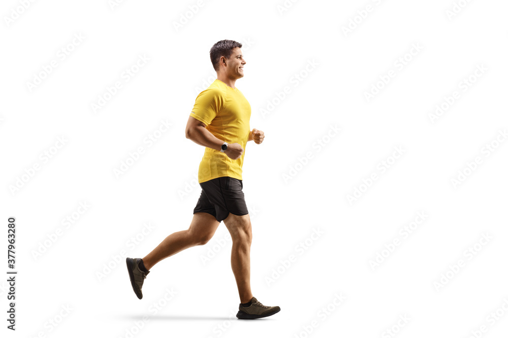 Fit man in a yellow t-shirt and black shorts running