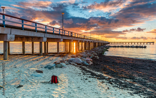 Colorful sunset near a marine pier at the Baltic Sea tourist resort,  Europe