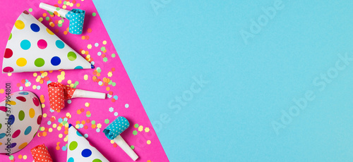 Birthday party background on blue and pink color. Party accessories on multicolored
