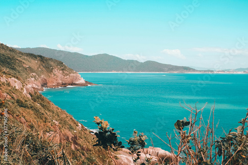 Beautiful view of the ocean surrounded by the mountains photo