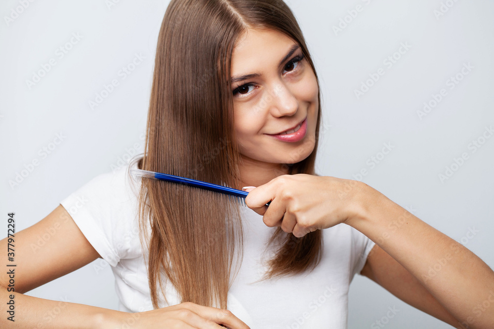 Closeup Of Beautiful Woman Hairbrushing Hair With Brush Closeup Of Beautiful Woman Hairbrushing Hair With Brush