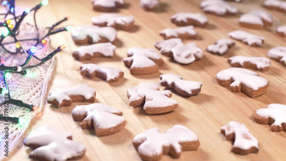Person decorating gingerbread cookies for Christmas. Person decorating gingerbread cookies for Christmas.