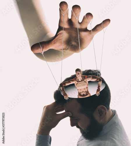 Photo Marionette in human head. Concept of mind control. Image