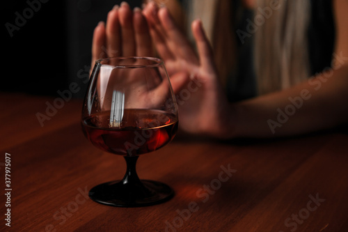 Young woman alcoholic social problems concept sitting refusal of alcohol