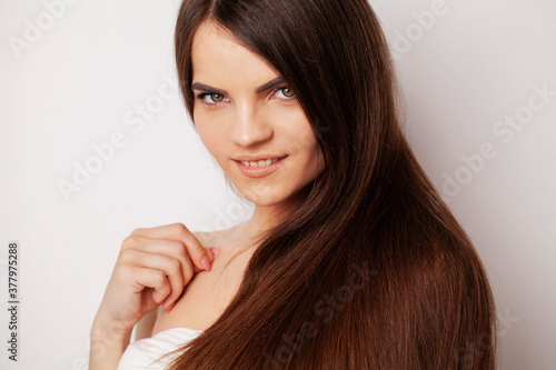 Portrait of the beautiful young woman with long brown hair