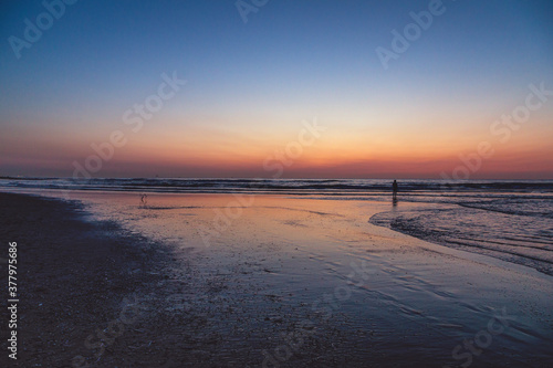 Fototapeta Naklejka Na Ścianę i Meble -  Sunset at North Sea Kijkduin Beach in the Netherlands where the land, sea and sky meet