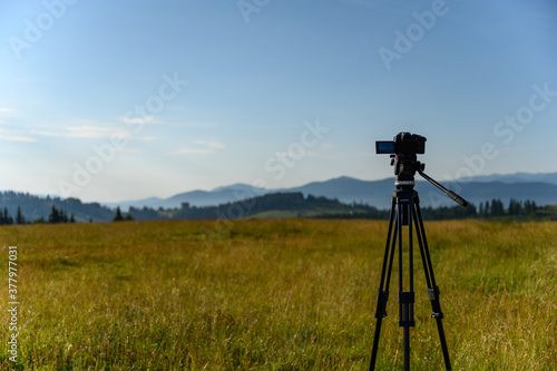  camera with tripod take photo on mountain beautiful view