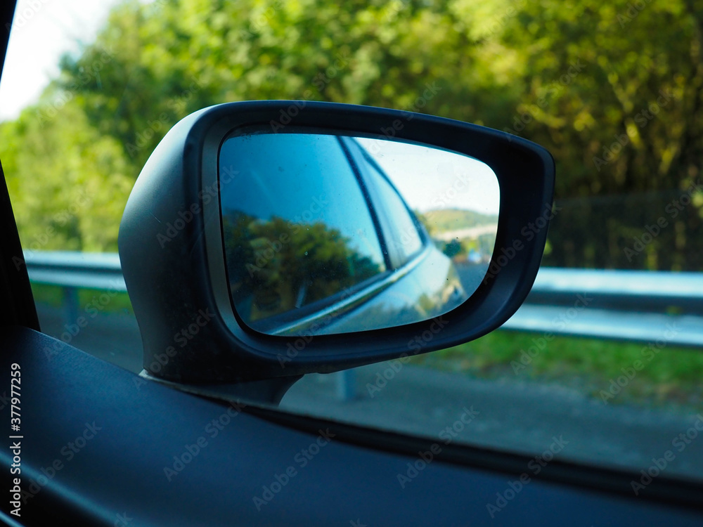 photo of a rearview of a car in movement